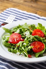 Green salad made with  arugula, tomatoes and sesame