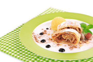 Tasty homemade apple strudel mint leaves and ice-cream