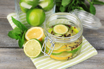 Pickled limes and cloves in glass jar,