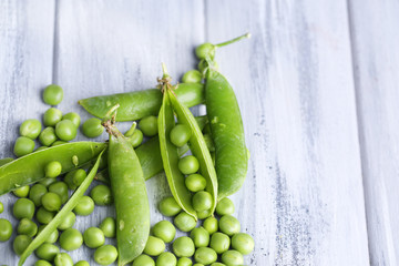 Fresh green peas on wooden background