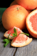 Ripe grapefruits on wooden background
