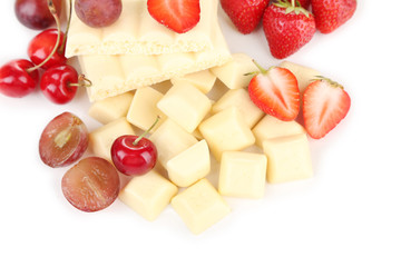 White chopped chocolate bar with fresh berries, isolated