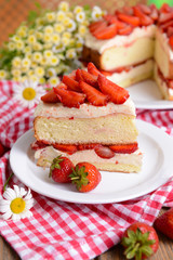 Delicious biscuit cake with strawberries on table close-up