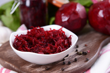 Grated beetroots in bowl on table close-up