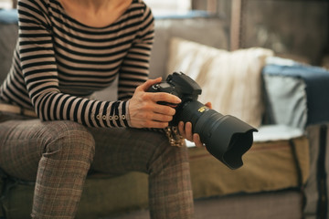 Closeup on young woman with modern dslr photo camera