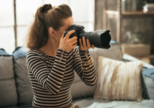 Young woman using modern dslr photo camera
