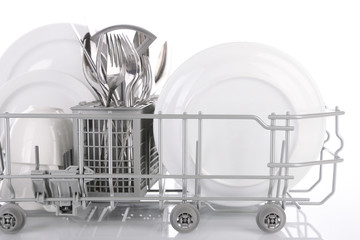 Clean dishes drying on metal dish rack, isolated on white