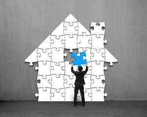 Assembling blue puzzles into house shape