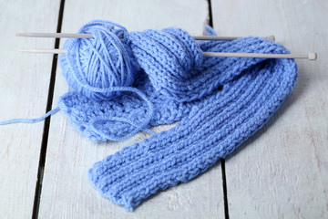 Yarns for knitting on wooden table close-up