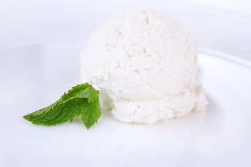 Vanilla ice cream balls on plate, isolated on white