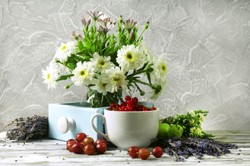 Obraz na płótnie Canvas Still life with flowers and fruits on table