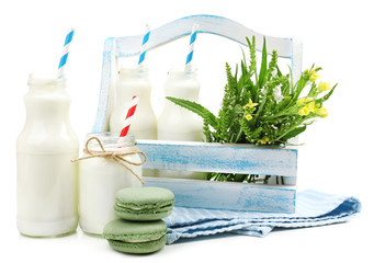 Milk in bottles with paper straws isolated on white