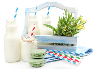 Milk in bottles with paper straws isolated on white