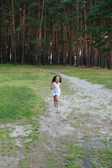 A beautiful little girl child kid laughing and running in white