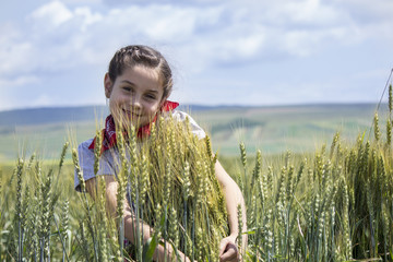 Young girl on a wheat field.Blurred background