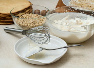 Ingridients for preparing sweet cake with nuts and cream