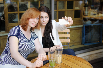 Two young girls taking selfie