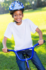 young african girl riding a bike