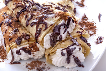 Pancakes with whipped cream topped with chocolate