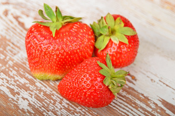 Some red strawberry on wooden background, DOF