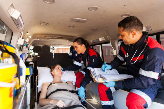 paramedics talking to patient on ambulance