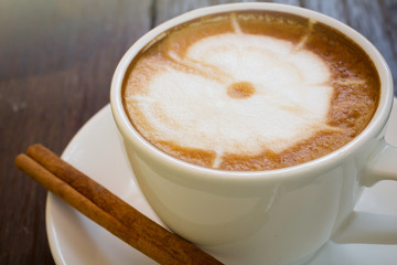 Coffee cup with cinnamon stick,