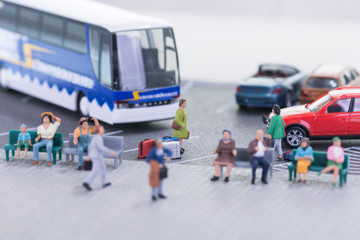 Miniature travellers at a bus station