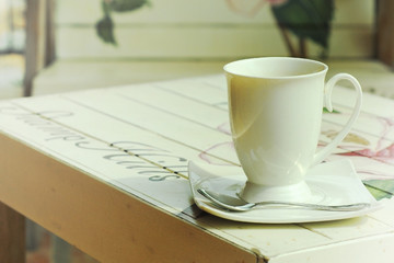 hot coffee on paint wooden table with vintage style