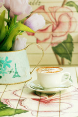 hot cappuccino on paint wooden table with vintage style