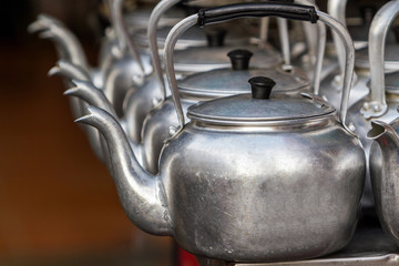Small classic kettle in row.