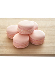 five pink macaroon on wooden tray