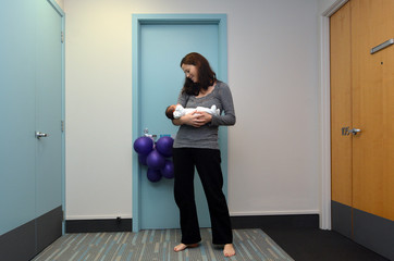 Fototapeta na wymiar Mother holds her newborn baby