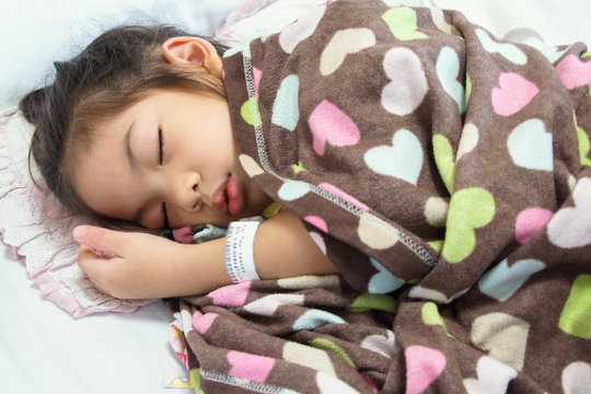 Young Baby Girl as Patient Sleeping on Hospital Bed