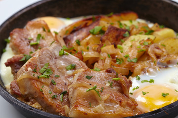 fried meat with potatoes and egg