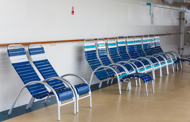 Blue and White Chairs on Deck of Ship