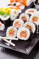 Delicious sushi pieces served on black stone