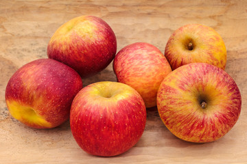 Fresh red apples on a hand carved wooden bowl
