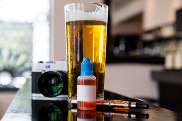Beer, camera, vaping juice and vaporizer