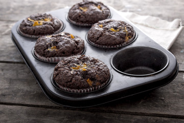 Chocolate cupcakes on a wooden table.