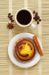 Cup of hot coffee and cupcake