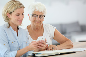 Homehelp booking medical appointment for elderly woman