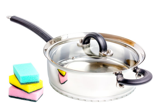 Stainless steel deep stewing pan with sponges on white
