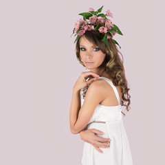 Beautiful young woman with delicate flowers