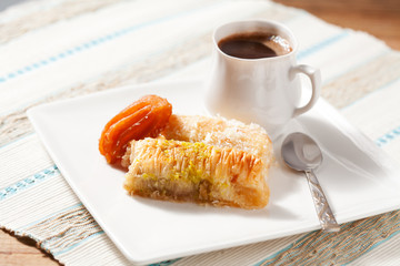 Oriental sweets assortment with cup of coffee, textured