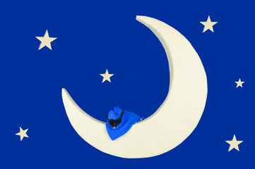 Fototapeta na wymiar kitten sleeps on the moon in the night sky
