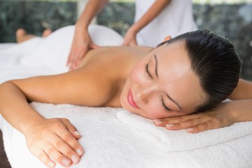Obraz na płótnie Canvas Content brunette enjoying a back massage