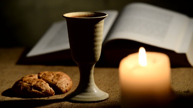 flaming candle and chalice of wine,rack focus