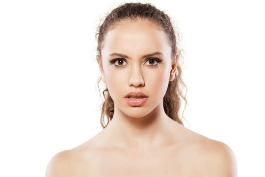 portrait of stunned young girl on white background
