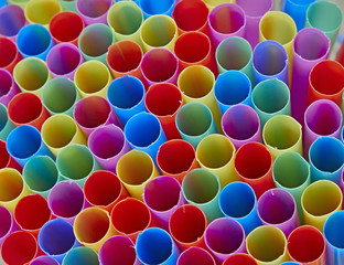 variety of drinking straws, colorful background