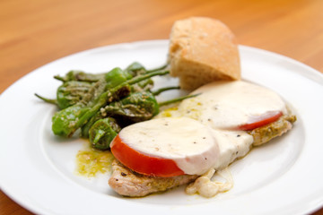 Beef cutlet with mozzarella, tomatoes and pimientos de padrón